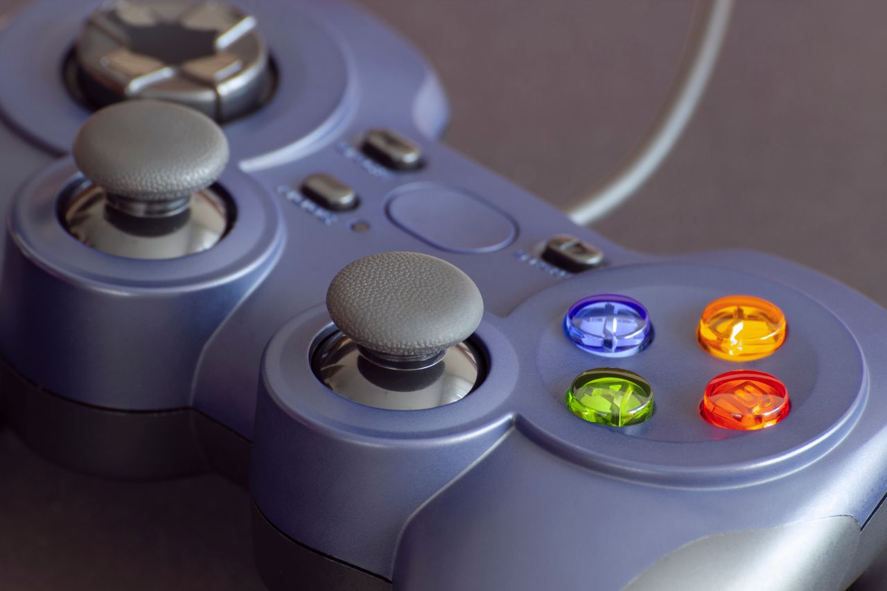Detailed close-up of a gaming controller emphasizing its vibrant buttons.
